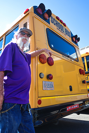 QCUSD school bus driver posing for a picture next to bus