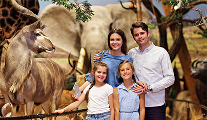 family standing in front of a museum exhibit