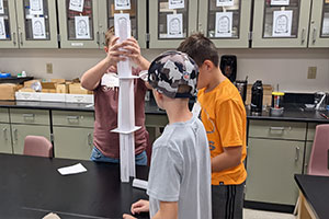 Students stacking paper cylinders