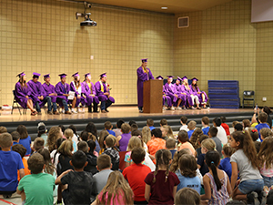 Graduates on stage at assembly