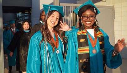 Two happy graduates smiling for the camera