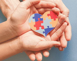 heart puzzle in the palm of a child's hands