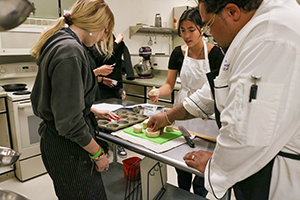 students cooking with a chef