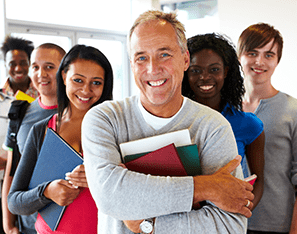 group of teachers holding books and smiling