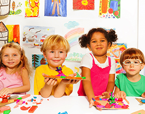 Kindergarten students with art projects