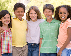 group of elementary students standing together wearing pastel colors