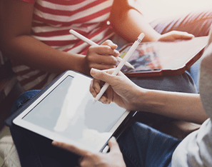 two students using a stylus on a tablet device