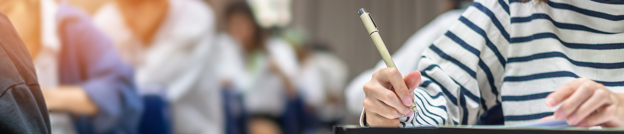 students sitting at desks writing