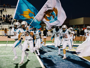 Football team running with flags