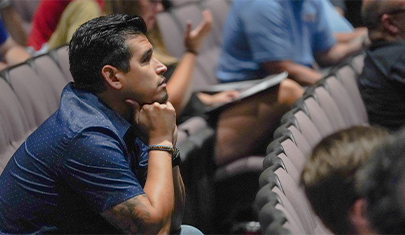 one teacher sitting in a conference hall