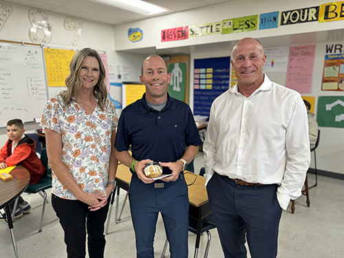 Superintendent Dr. Perry Berry pictured with award of excellence nominee Jeff Sutter and QCES Principal Dawn Michaelson