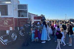 Students learning about fire science outside next to a fire truck