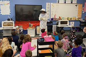 Bee keeper visiting students in the classroom