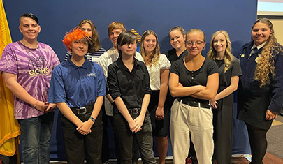 students lined up in front of blue background