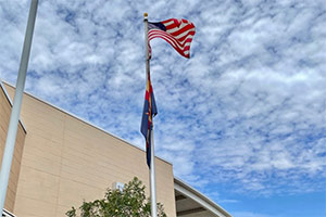 American flag raised in front of the school