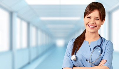 Young female nurse smiling in hallway