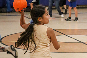 Girl having fun tossing ball on the court