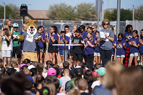 School mascot on stage with the other students