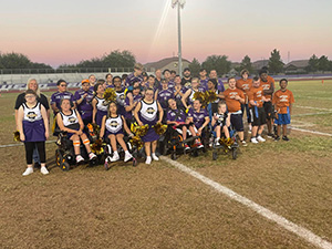Group photo of students with and without disabilities on football field