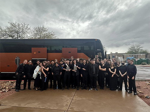 Jazz band group photo outside in front of a bus 