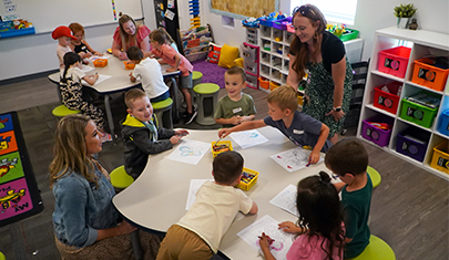 Kindergarten teachers with their students in the classroom