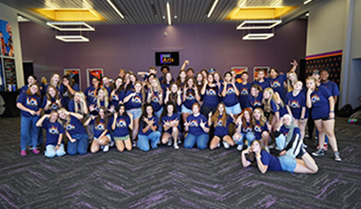 Happy group of students wearing LOL t-shirts at the conference