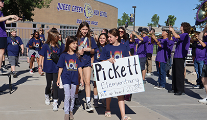 Students marching outside with Pickett poster