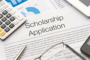 Photo of scholarship application and calculator