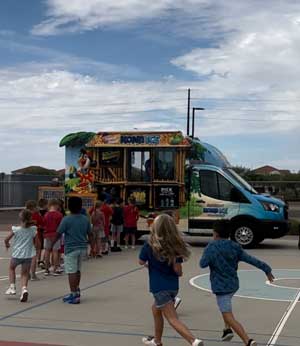 students lining up at Kona Ice truck