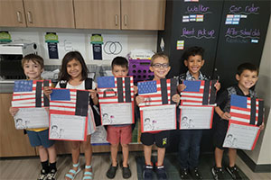 Students holding Patriot Day messages in class