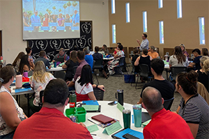 Teachers attending new teacher induction at the district office