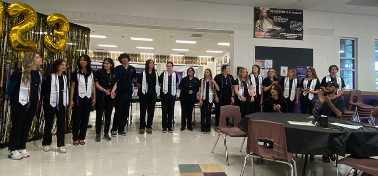 Thirteen students wearing their sashes for completing their certified nursing assistant program