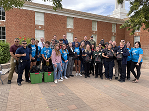 Group of students outside with police team