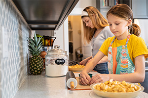 Mother and daughter cooking together