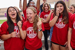Members of Lead Out Loud dressed in red t-shirts and laughing