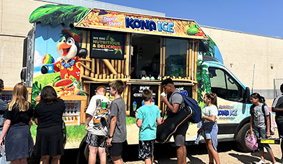 Kona Ice truck with students standing around