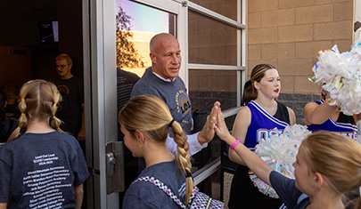 QCUSD Superintendent Berry high fives a student entering the building