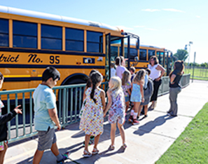 Studented lined up and walking onto school bus