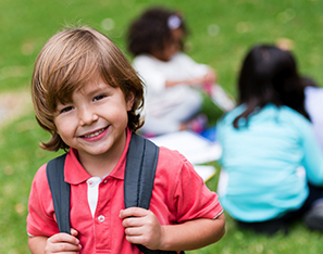 Kindergarten student outside with backpack